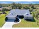 Expansive aerial view of a single-Gathering home featuring manicured landscaping, and a spacious driveway at 1284 Sorrento Woods Blvd, Nokomis, FL 34275