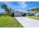 Inviting single-story home featuring a spacious driveway, well-maintained lawn, and attached two-car garage at 1284 Sorrento Woods Blvd, Nokomis, FL 34275