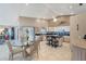 A modern kitchen with white cabinetry, an island with seating, and a breakfast nook under a soaring ceiling at 1284 Sorrento Woods Blvd, Nokomis, FL 34275