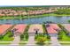 An aerial view of a residential home showcasing its location on the lake and red tile roof at 1290 Cielo Ct, North Venice, FL 34275