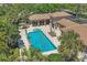Aerial view of the community pool area featuring a pool, lounge chairs, and a covered seating area at 1290 Cielo Ct, North Venice, FL 34275