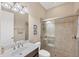 Bright bathroom showcasing a glass-enclosed shower and single sink vanity with framed pictures at 1290 Cielo Ct, North Venice, FL 34275