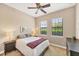 Bedroom featuring a queen bed, neutral walls, carpet, two windows, and ceiling fan at 1290 Cielo Ct, North Venice, FL 34275