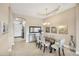 Elegant dining room features stylish chandelier, mirror, and tile flooring at 1290 Cielo Ct, North Venice, FL 34275