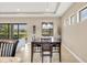 Bright dining area with views of the backyard, adjacent to a kitchen and living area at 1290 Cielo Ct, North Venice, FL 34275