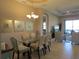 Chic dining area adjacent to the living room, showcasing stylish decor and ample natural light from the nearby windows at 1290 Cielo Ct, North Venice, FL 34275