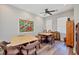Bright dining room featuring two tables and four chairs each, wood-look flooring, and a large decorative wall art piece at 1290 Cielo Ct, North Venice, FL 34275
