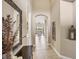 Inviting hallway with neutral color palette, decorative wall art, and a glimpse into the bright living area at 1290 Cielo Ct, North Venice, FL 34275