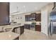 Well-equipped kitchen with stainless steel appliances and dark wood cabinets at 1290 Cielo Ct, North Venice, FL 34275