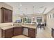 Beautiful kitchen with dark wood cabinets, granite countertops, and stainless steel appliances at 1290 Cielo Ct, North Venice, FL 34275