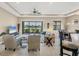 Comfortable living room with tile floors, neutral walls, and a view of the serene lake at 1290 Cielo Ct, North Venice, FL 34275