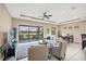 Bright living room with tile floors and a sliding glass door that has lovely lake views at 1290 Cielo Ct, North Venice, FL 34275