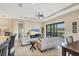 Open living area with ceiling fan, access to outdoors, and views of pond at 1290 Cielo Ct, North Venice, FL 34275