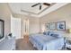 This main bedroom has neutral walls, carpet, white trim, and a queen bed facing three framed prints at 1290 Cielo Ct, North Venice, FL 34275
