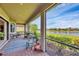 Enclosed patio overlooking a serene lake, perfect for relaxing and enjoying the peaceful scenery at 1290 Cielo Ct, North Venice, FL 34275