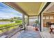 Relaxing screened-in porch with views of the lake, featuring a comfortable seating area at 1290 Cielo Ct, North Venice, FL 34275