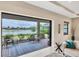 Cozy screened-in lanai with seating area, offering beautiful views of the lake and lush greenery at 1290 Cielo Ct, North Venice, FL 34275