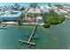 Aerial view of a Gulf Coast waterfront community with private dock access and manicured landscaping at 1325 Gulf Dr N # 247, Bradenton Beach, FL 34217