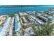 Aerial view of coastal condos with community pool, convenient parking, and scenic waterfront views at 1325 Gulf Dr N # 247, Bradenton Beach, FL 34217