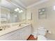 Bathroom vanity featuring a wide mirror, providing ample lighting and a clean, functional design at 1325 Gulf Dr N # 247, Bradenton Beach, FL 34217