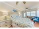 This bedroom includes tiled floors, seating area, and a floral bedspread at 1325 Gulf Dr N # 247, Bradenton Beach, FL 34217