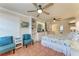 This is a cozy bedroom with tiled floors, a floral bedspread, and dual ceiling fans at 1325 Gulf Dr N # 247, Bradenton Beach, FL 34217