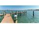 Beautiful new dock with weathered wooden pilings extends into the serene blue-green waters of the Gulf Coast at 1325 Gulf Dr N # 247, Bradenton Beach, FL 34217