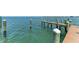 Dock with wooden pilings extends into the serene blue-green waters of the Gulf Coast at 1325 Gulf Dr N # 247, Bradenton Beach, FL 34217