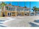 The front view of the resort building shows balconies that offer scenic views and pedestrian walkway and beach front access at 1325 Gulf Dr N # 247, Bradenton Beach, FL 34217