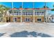 The resort's exterior with a spacious parking area in front and balconies that offer views of the surroundings at 1325 Gulf Dr N # 247, Bradenton Beach, FL 34217