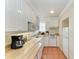 Efficient kitchen featuring white cabinetry, wooden countertops, and modern appliances for easy meal preparation at 1325 Gulf Dr N # 247, Bradenton Beach, FL 34217