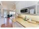 Compact kitchen featuring wooden countertops, white cabinets, and modern appliances for convenient cooking at 1325 Gulf Dr N # 247, Bradenton Beach, FL 34217