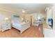 Cozy bedroom with a comfortable bed, ceiling fan, and compact kitchen for easy living at 1325 Gulf Dr N # 247, Bradenton Beach, FL 34217