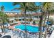 Lovely community pool surrounded by palm trees with lounge chairs for residents to relax and enjoy at 1325 Gulf Dr N # 247, Bradenton Beach, FL 34217