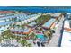 Aerial view of a charming coastal resort with a pool, palm trees, and stunning ocean views at 1325 Gulf Dr N # 248, Bradenton Beach, FL 34217