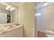 Bathroom with a single sink vanity, mirror, and toilet in a clean and bright space at 1325 Gulf Dr N # 248, Bradenton Beach, FL 34217