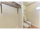 Bright bathroom featuring a toilet, bidet, open closet, and beige walls with a terracotta tile floor at 1325 Gulf Dr N # 248, Bradenton Beach, FL 34217