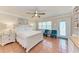 Bedroom features a ceiling fan, terracotta flooring, and two blue chairs at 1325 Gulf Dr N # 248, Bradenton Beach, FL 34217