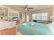 Bright bedroom features built-in shelves, desk, and a comfortable queen-size bed with teal quilt at 1325 Gulf Dr N # 248, Bradenton Beach, FL 34217