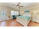 Sunlit bedroom with a comfortable queen-size bed, turquoise chairs, and a charming beach-themed decor at 1325 Gulf Dr N # 248, Bradenton Beach, FL 34217