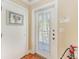 Clean entryway with tile flooring, white doors, and visible fire extinguisher for safety at 1325 Gulf Dr N # 248, Bradenton Beach, FL 34217