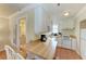 Functional kitchenette with a breakfast bar, white appliances, and an adjacent bathroom at 1325 Gulf Dr N # 248, Bradenton Beach, FL 34217