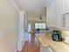 Open living area featuring a kitchenette, breakfast bar, and a comfortable bedroom setting in the background at 1325 Gulf Dr N # 248, Bradenton Beach, FL 34217