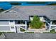 A bird's eye view showcases the well-kept condos surrounded by lush greenery and stunning water views at 1389 Perico Point Cir # 140, Bradenton, FL 34209