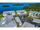 Overhead shows condominium complex with parking by the bay, surrounded by lush landscapes and scenic views of the water at 1389 Perico Point Cir # 140, Bradenton, FL 34209