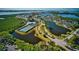 A beautiful aerial view of the community, with waterways, tennis courts, and lush landscaping at 1389 Perico Point Cir # 140, Bradenton, FL 34209