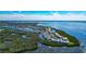 Panoramic aerial view of waterfront condos, winding waterways, and lush nature at 1389 Perico Point Cir # 140, Bradenton, FL 34209