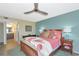 Cozy bedroom with a warm color scheme, bedside tables, and a peek at the bathroom at 1389 Perico Point Cir # 140, Bradenton, FL 34209
