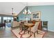 Inviting dining area with modern chandelier, artwork, and comfortable seating adjacent to open living space at 1389 Perico Point Cir # 140, Bradenton, FL 34209