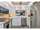Bright kitchen with stainless appliances, white cabinets, and a window view at 1389 Perico Point Cir # 140, Bradenton, FL 34209